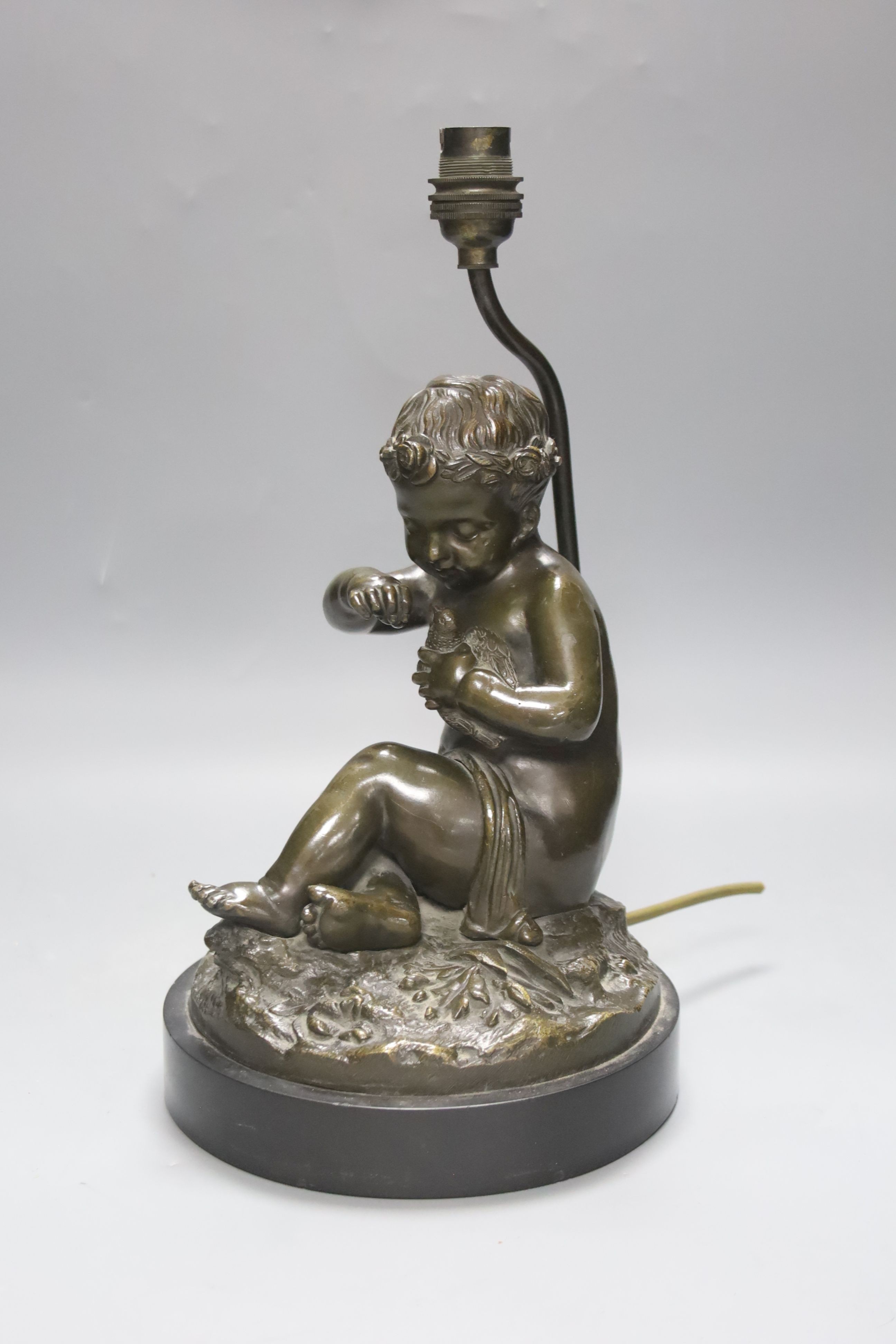 A late 19th century French bronze lamp base, putto and dove, 34cm total